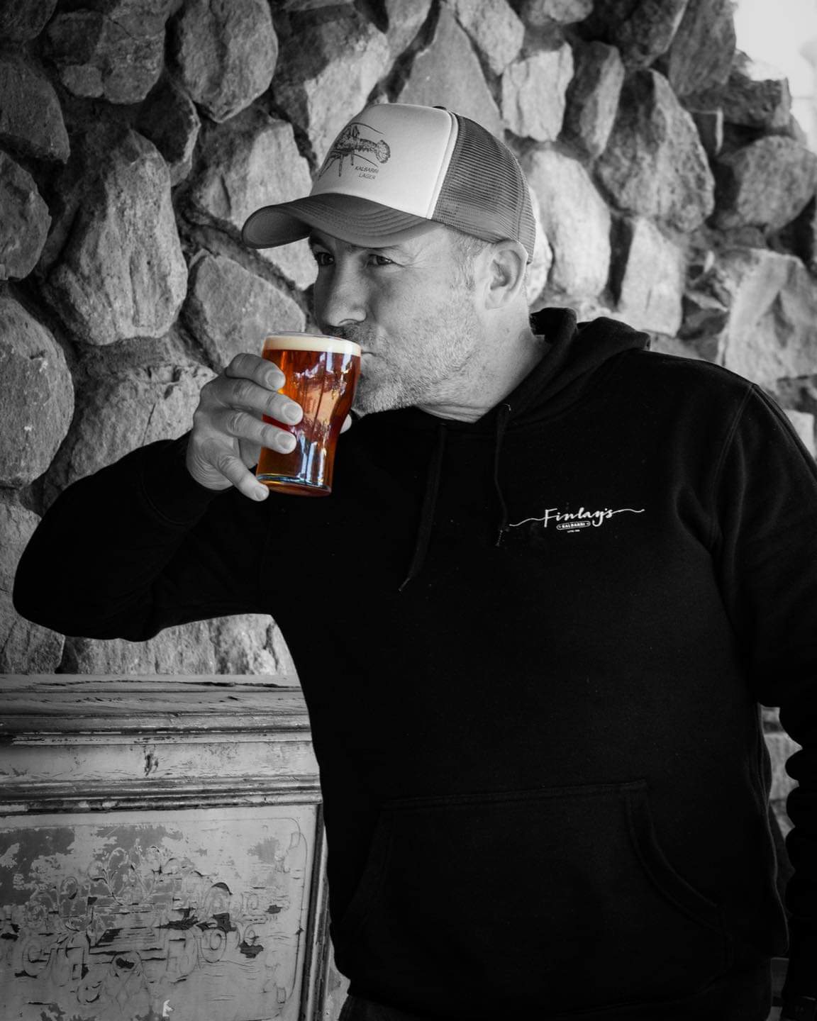 Warrick, Head Brewer at Finlay's Brewing Co samples beer from a glass